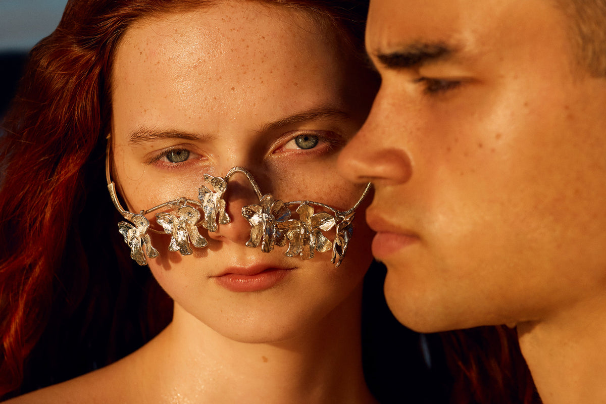 Woman wearing decorative glasses with a man in a desert setting